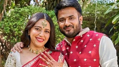 Swara Bhasker and her partner smiling outdoors in traditional attire.