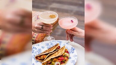Two cocktails and a plate of Indian food at Tandoor Tina restaurant in Dubai.