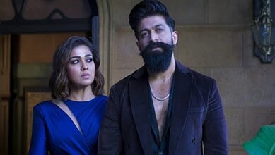 Two actors, a woman and a man, in a scene from a film or TV show, with serious expressions.