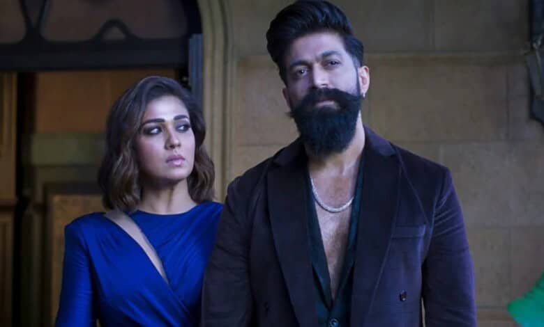 Two actors, a woman and a man, in a scene from a film or TV show, with serious expressions.