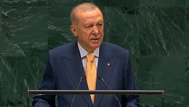 Turkish President speaking at UN General Assembly with green background.