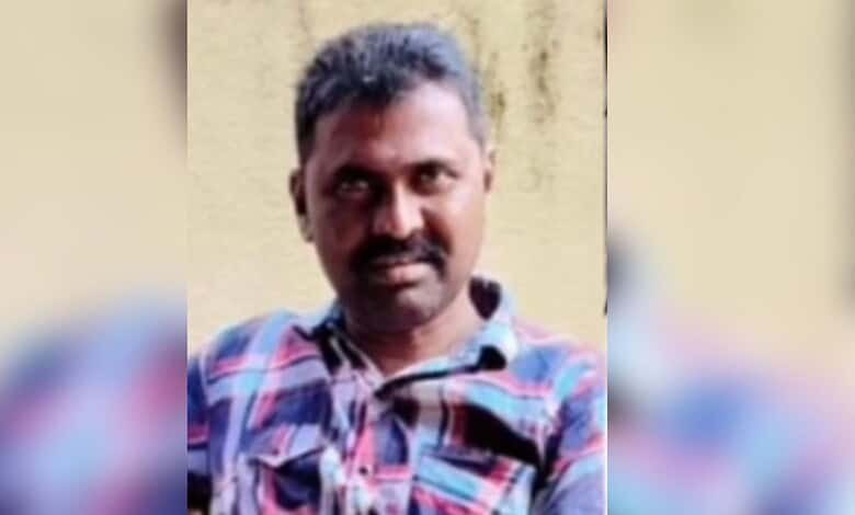 Portrait of a Telangana man with a mustache wearing a checkered shirt.