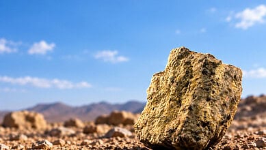 Uranium ore rock in desert landscape.