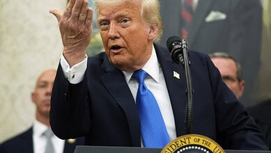 US President Donald Trump speaks at a podium and gestures.