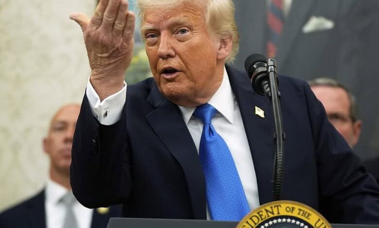 US President Donald Trump speaks at a podium and gestures.