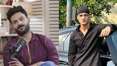 Vishal Aditya Singh in a black shirt and cap, leaning on a car outdoors.
