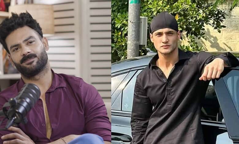 Vishal Aditya Singh in a black shirt and cap, leaning on a car outdoors.
