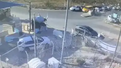 Vehicles involved in a ramming attack in the West Bank, with police and emergency response present.