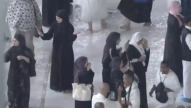 Worshippers brave heavy rain at the Grand Mosque in Makkah during prayer.
