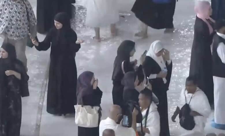 Worshippers brave heavy rain at the Grand Mosque in Makkah during prayer.