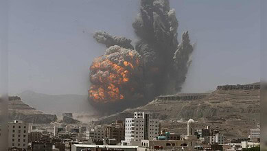 Massive explosion and smoke rising over cityscape after attack on telecom towers in Yemen.