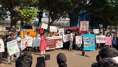 Hyderabad students protest at Jantar Mantar against crackdown, holding signs and banners.