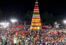 Saddula Bathukamma celebrations at Tank Bund with a large decorated conical structure and crowds.