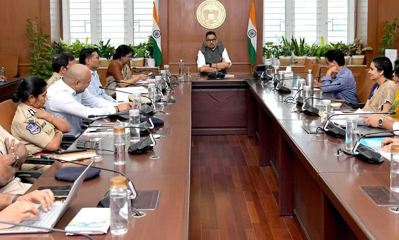 Officials and organizers discuss preparations for Bathukamma Festival in a formal meeting room.