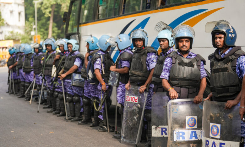 Line of police officers in riot gear at Jantar Mantar protest site in India.