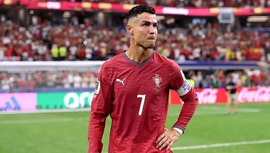 Portuguese footballer Cristiano Ronaldo in Portugal national team jersey on the field.