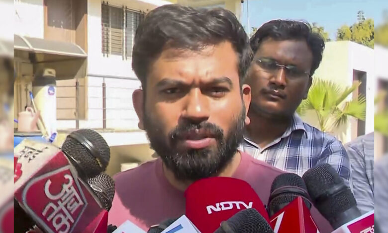 Rahul Gandhi speaking to media with microphones from NDTV, Aaj Tak, and others in the background.