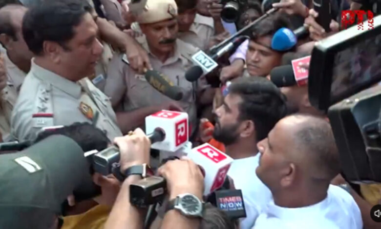 Police detain Abhijeet Dipke during Tiranga march in Delhi amid media coverage.
