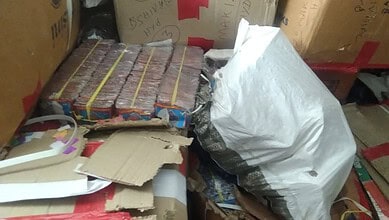 Seized firecrackers and packaging materials in a storage area before Diwali.