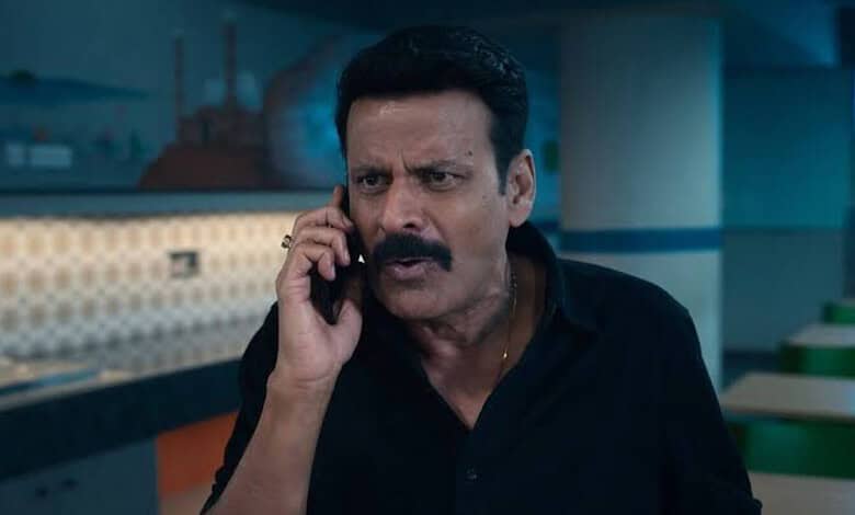 Manoj Bajpayee in a scene from Ghooskhor Pandat, looking serious and talking on the phone.