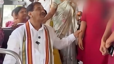Congress MLA touching woman on bus, surrounded by onlookers, during a public event.