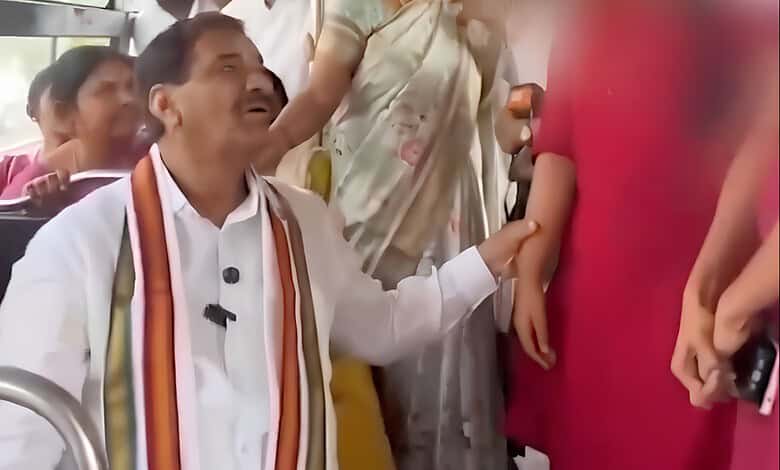 Congress MLA touching woman on bus, surrounded by onlookers, during a public event.