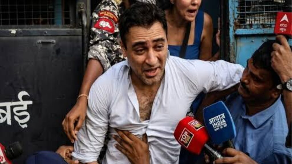 Actor Imran Khan surrounded by media and supporters during a protest event.