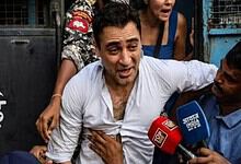 Actor Imran Khan surrounded by media and supporters during a protest event.