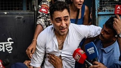 Actor Imran Khan surrounded by media and supporters during a protest event.