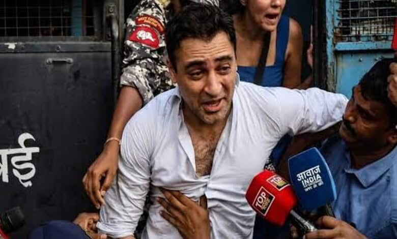 Actor Imran Khan surrounded by media and supporters during a protest event.