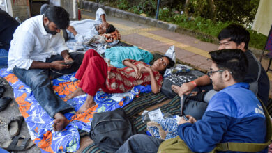 Students resting on the ground during a protest at JNU campus.