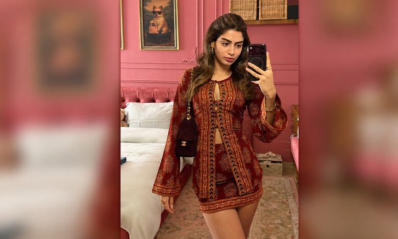 Khushi Kapoor taking a mirror selfie in a pink-themed room, wearing a traditional embroidered outfit.
