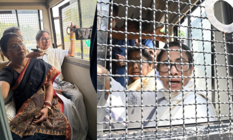 Protesters and detained individuals behind metal barriers during a demonstration.
