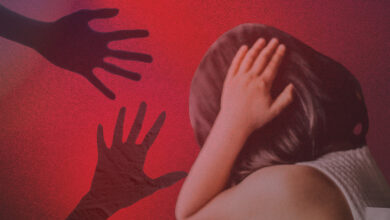 Child shielding face from shadowy hands representing online abuse risks.