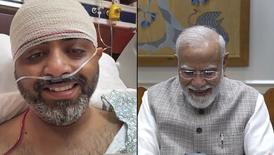 Indian man in hospital bed with nasal oxygen tube, smiling, after medical treatment.