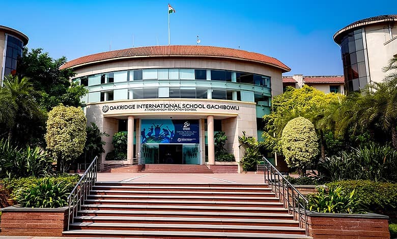 Oakridge International School Gachibowli building with lush greenery and clear blue sky.