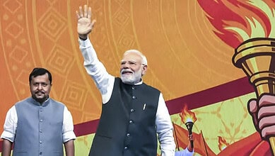 Prime Minister Narendra Modi waving at the crowd during a patriotic event.