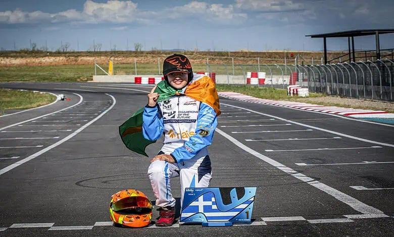 Indian girl Atiqa Mir in racing gear with helmet and trophy at Kart Republic track.