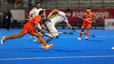 India and Pakistan hockey players compete fiercely during an Asian Games match.