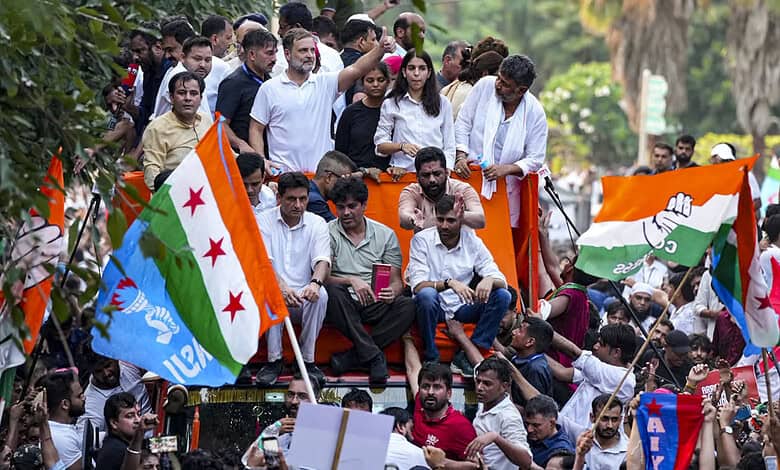 Protesters gather on a vehicle with Indian flags during a demonstration in Delhi.