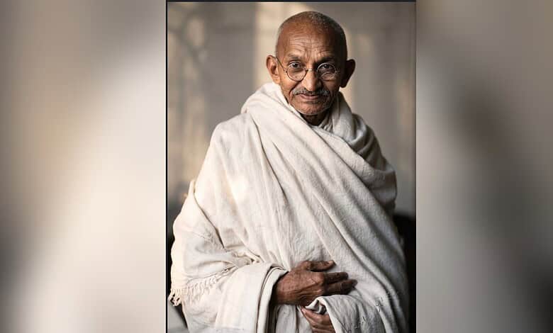 Mahatma Gandhi in traditional attire, sitting and smiling, reflecting on films he watched.
