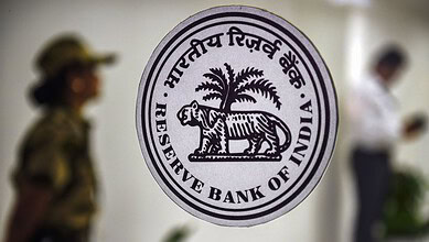 Close-up of the Reserve Bank of India emblem with a tiger and palm tree.