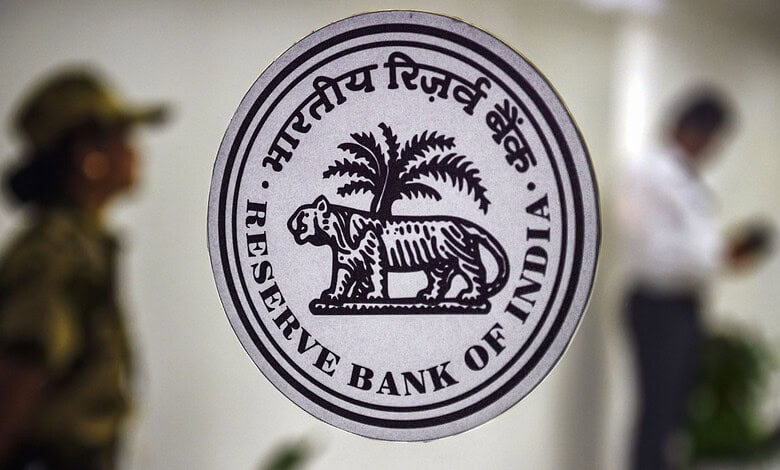 Close-up of the Reserve Bank of India emblem with a tiger and palm tree.