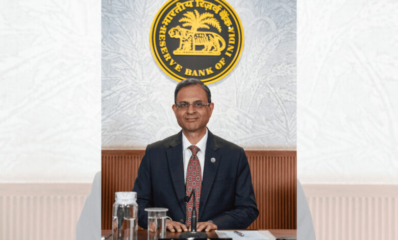 Reserve Bank of India official in formal attire at a press conference or event.