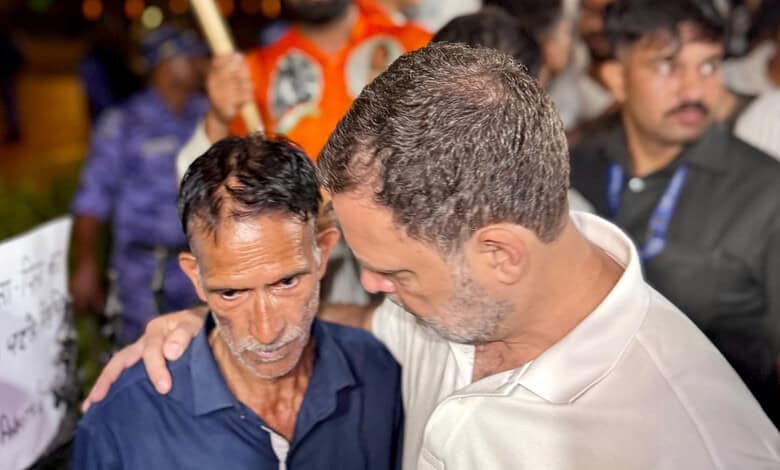 Rahul Gandhi comforting a man at a public event in India.