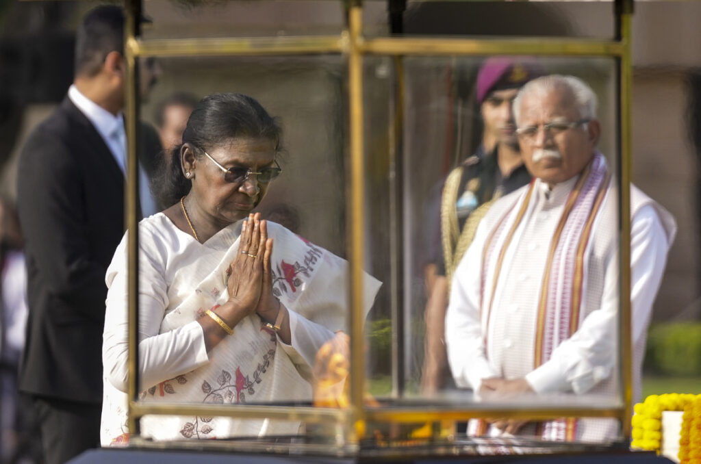 Prime Minister Narendra Modi and other officials pay homage during Mahatma Gandhi's birth anniversary.