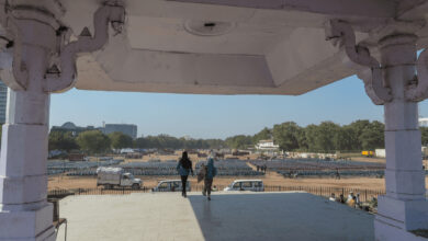 View of Ramlila Maidan from a pavilion with two people standing and looking out.