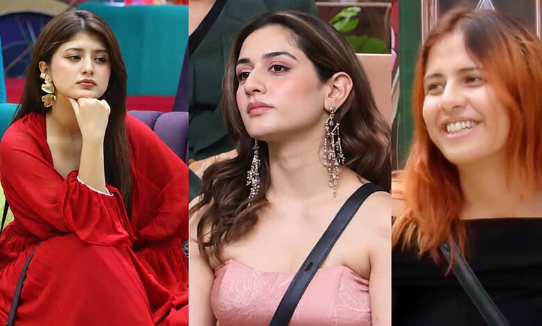 Three female contestants in Bigg Boss 20 during eviction episode, showing varied expressions.