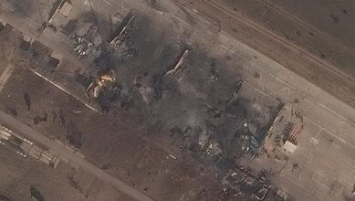 Aerial view of damaged buildings and smoke after an attack on a Russian oil refinery.