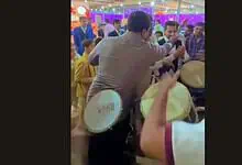 Wedding guests in Hyderabad protesting with drums during a celebration.